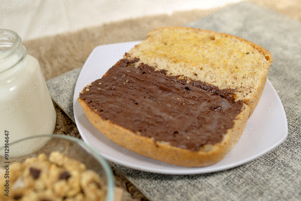 Bread with chocolate spread filling, milk and snack for breakfast
Bread with chocolate spread filling, milk and snack for breakfast