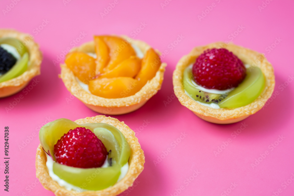 Plate tartlets with fruit in pink on a . food summer slice concept. a plate of tartlets with pieces of fruit on a pink . a plate of tartlets in pink with pieces of fruit on lifestyle the. Plate tartlets with fruit in pink on a . food summer slice concept. a plate of tartlets with pieces of fruit on a pink . a plate of tartlets in pink with pieces of fruit on lifestyle the.