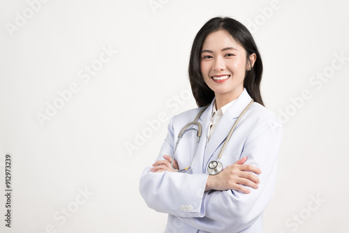 Portrait female doctor wearing medical uniform and stethoscope at hospital.Beautiful smiling young asian woman doctor isolated on white background.Doctor arms crossed wear white coat and stethoscope.