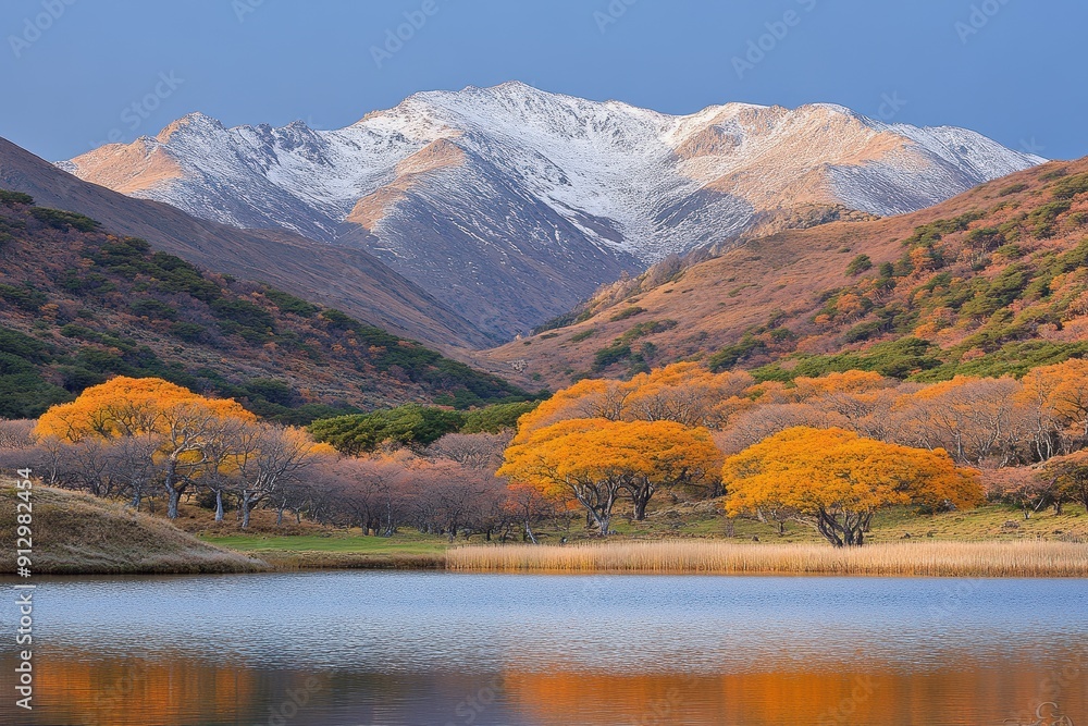 Obraz premium Majestic autumn landscape with colorful trees and snow-capped mountains