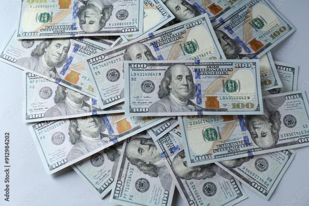 Many dollar banknotes on light grey background, top view Many dollar banknotes on light grey background, top view