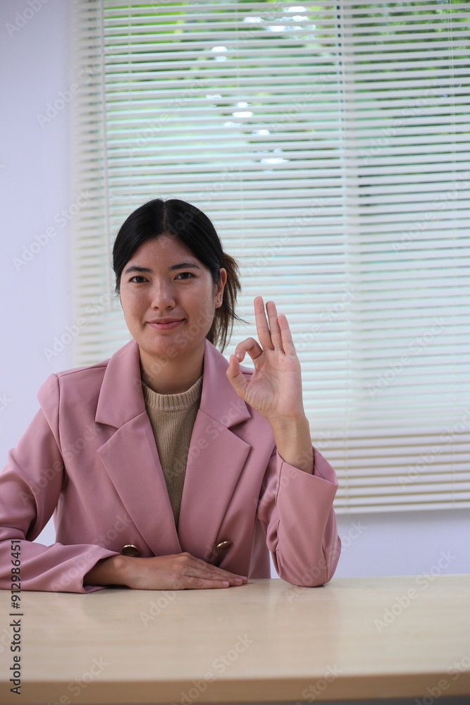 Successful Asian businesswoman sitting at desk working using laptop computer in office. Business and people concept. Businesswoman using laptop computer and working with documents. Successful Asian businesswoman sitting at desk working using laptop computer in office. Business and people concept. Businesswoman using laptop computer and working with documents.