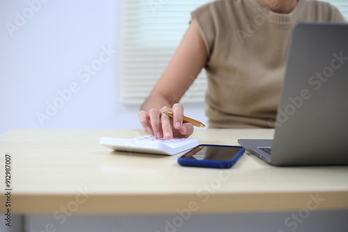 Successful Asian businesswoman sitting at desk working using laptop computer in office. Business and people concept. Businesswoman using laptop computer and working with documents.