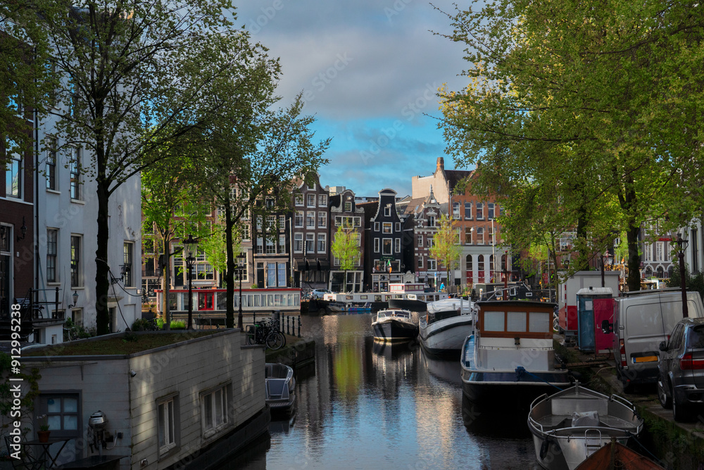 Obraz premium Facades of old historic Houses and trees over canal water, Amsterdam, Netherlands