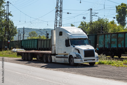 Wallpaper Mural White bonnet truck with a semitrailer at a freight railway station in the countryside Torontodigital.ca