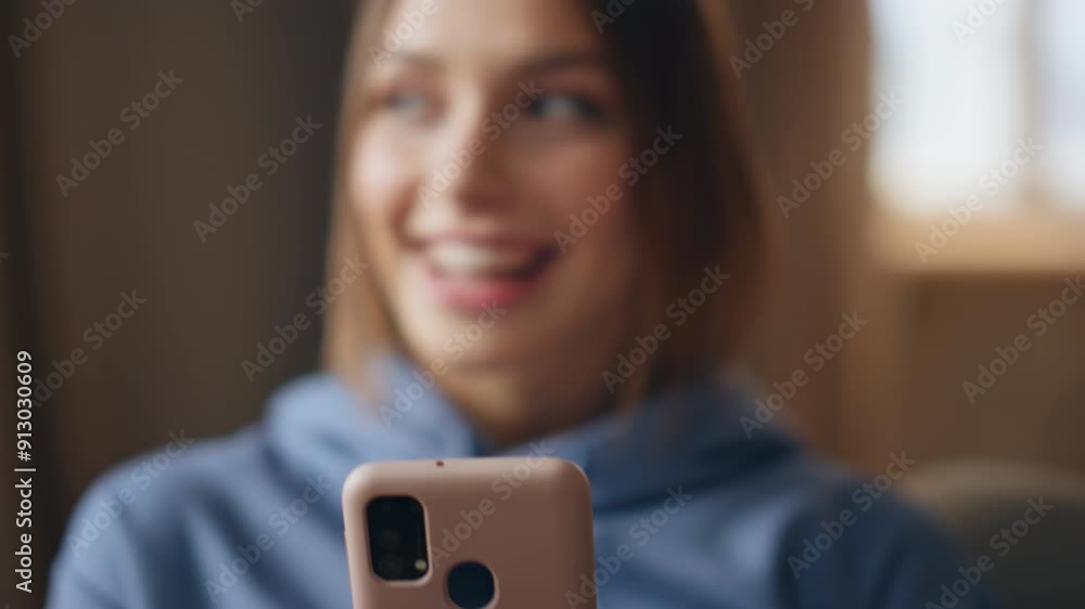 Excited girl reading message on cellphone at apartment closeup. Smiling woman Excited girl reading message on cellphone at apartment closeup. Smiling woman