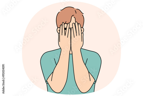 Man closes eyes with hands and peeps, feeling excited in anticipation of surprise or panic after receiving threats. Guy feels insecure and panic, trying to hide from problems that have arisen.