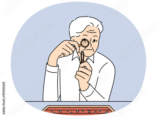 Elderly man jeweler examines diamond through magnifying glass checking gems for authenticity. Gray-haired worker in jewelry workshop chooses diamond to create necklace or engagement ring.