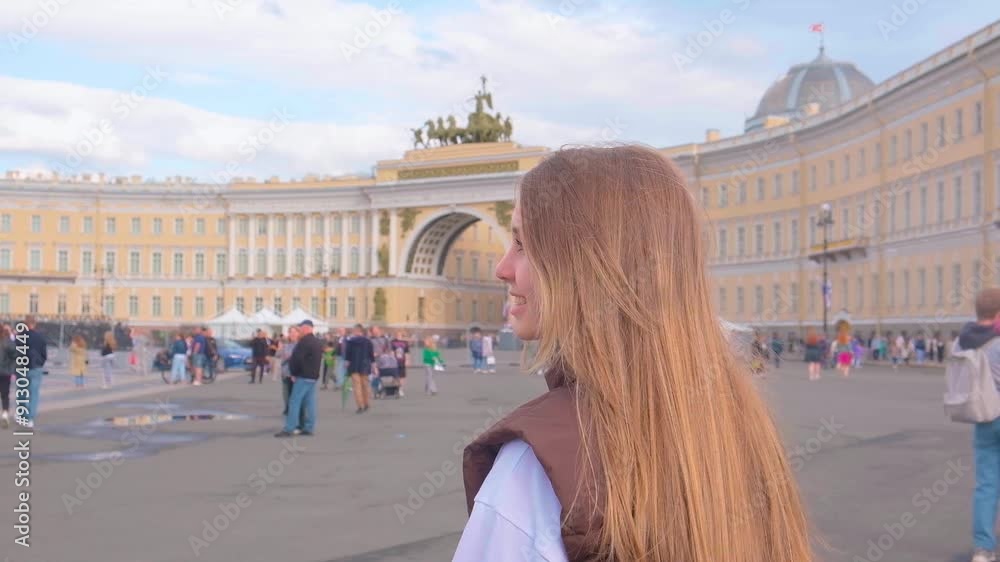 A beautiful young girl walks in the center of St. Petersburg along the embankments and attractions. Saint Petersburg, Russia - 28 June 2024