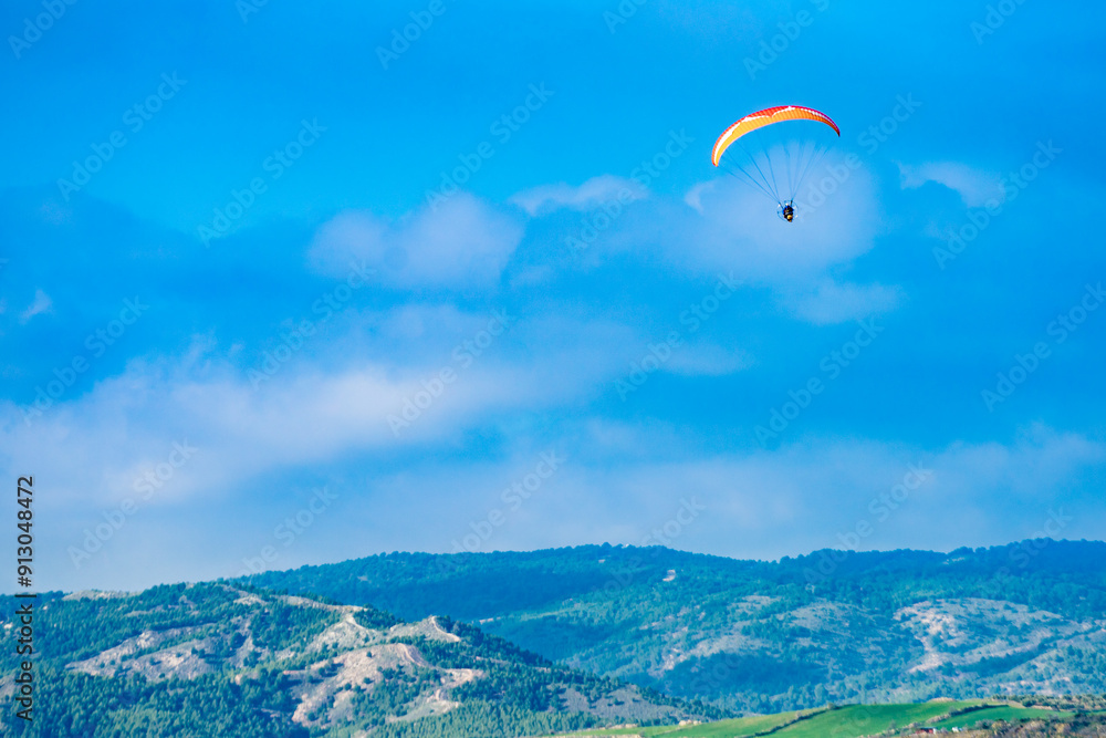 Paraglider flying over spanish nature landscape in Andalucia. Paraglider flying over spanish nature landscape in Andalucia.
