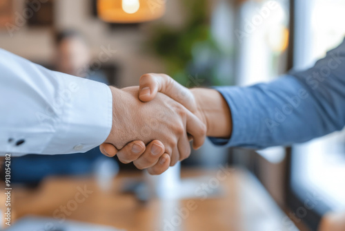 Two men shake hands in a business meeting