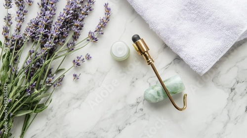 A flat lay of a natural skincare routine with essential oils, a jade roller, fresh lavender, and a white towel on a marble surface, promoting relaxation and self-care, copy space