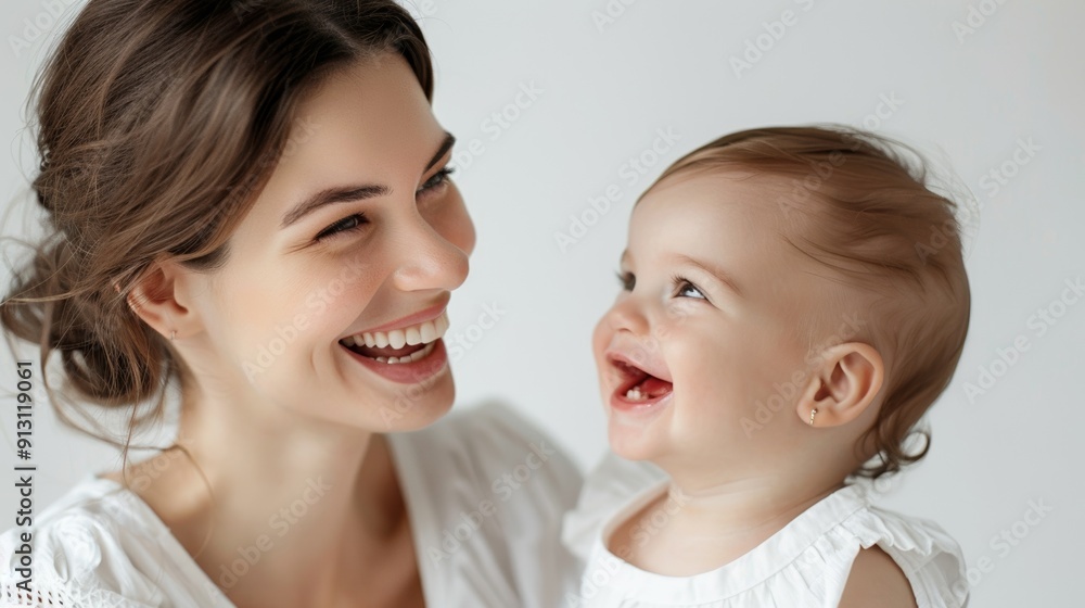 Gentle smiles of a mother and her happy baby, reflecting their mutual affection. Gentle smiles of a mother and her happy baby, reflecting their mutual affection.