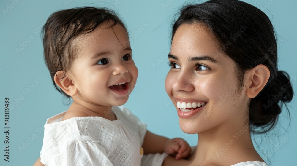 Gentle bond between a mother and her happy baby, reflecting their deep connection in a serene studio. Gentle bond between a mother and her happy baby, reflecting their deep connection in a serene studio.