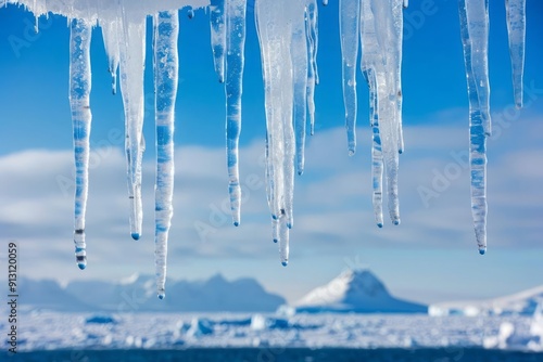 Icicles melting and dripping against a blue sky on the Antarctic peninsula, Antarctica