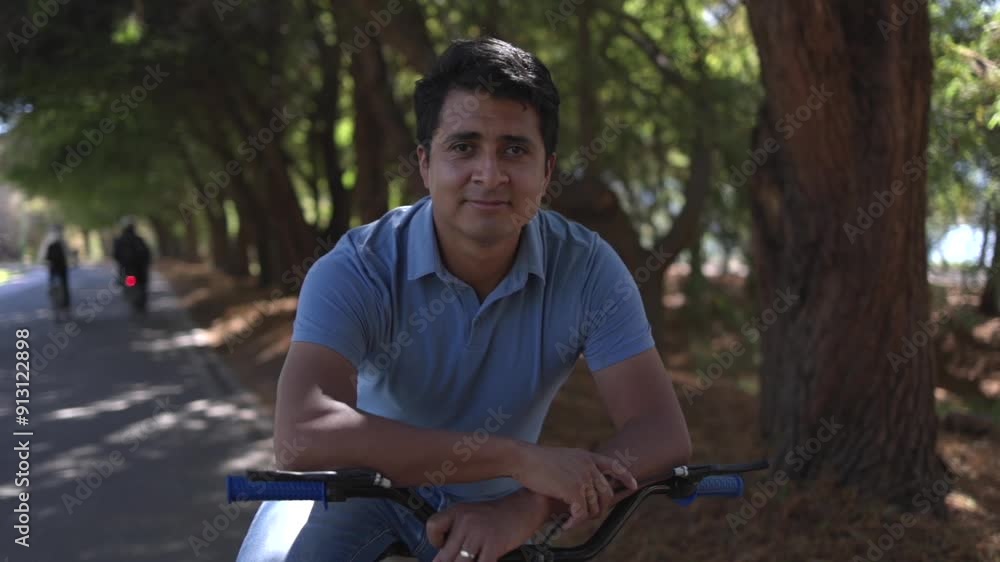 Portrait of a mexican man smiling and posing with a bicycle outdoors Portrait of a mexican man smiling and posing with a bicycle outdoors