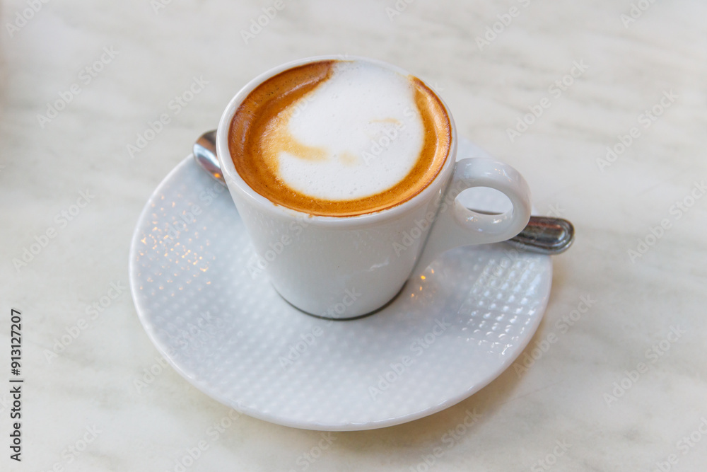 Cup of hot cappuccino coffee on a table Cup of hot cappuccino coffee on a table