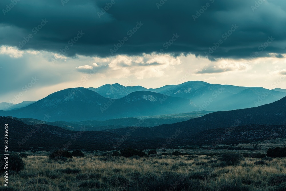 mountains at dusk, with large clouds in the sky mountains at dusk, with large clouds in the sky