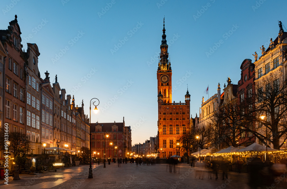 Fototapeta premium Street in an Old town and Town Hall in Gdansk, Poland. Panoramic evening view, long exposure, timelapse. Historical city of Gdansk (Danzig) , Poland, Europe.