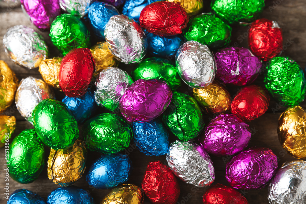 COLOURED EASTER EGGS. Easter celebration concept. Happy Easter. Chocolate sweet eggs. Candies on textured wooden table. Space for text.Copy space COLOURED EASTER EGGS. Easter celebration concept. Happy Easter. Chocolate sweet eggs. Candies on textured wooden table. Space for text.Copy space