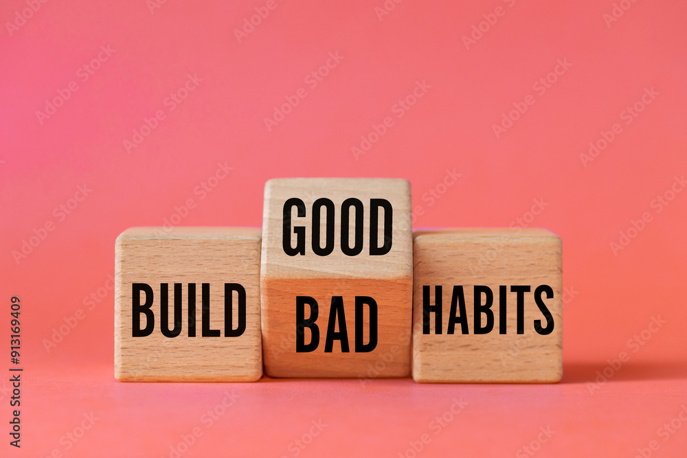 Symbol of building good or bad habits. Turned wooden block and changing the word Build Bad Habits to Build good Habits. Beautiful apricot background. Business concept. Copy space
