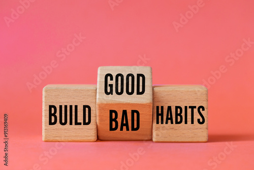 Obraz na płótnie Symbol of building good or bad habits. Turned wooden block and changing the word Build Bad Habits to Build good Habits. Beautiful apricot background. Business concept. Copy space w salonie