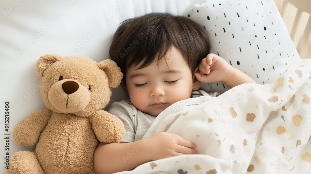 Sweet baby sleeping peacefully with a teddy bear in bed. Cozy indoor nap time scene. Sweet baby sleeping peacefully with a teddy bear in bed. Cozy indoor nap time scene.