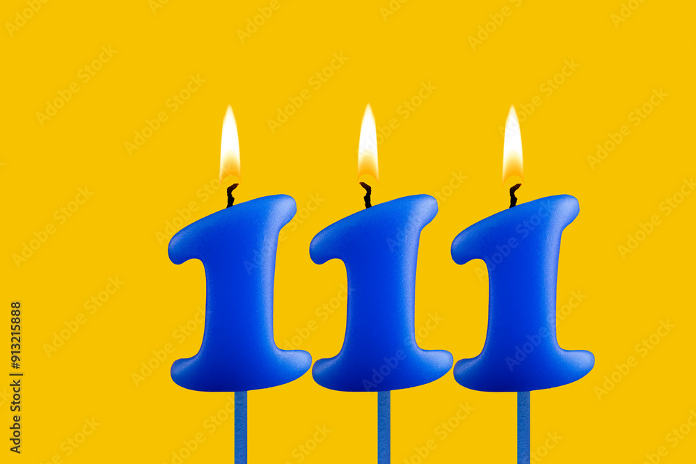 Blue candle number 111 - Birthday on yellow background Blue candle number 111 - Birthday on yellow background