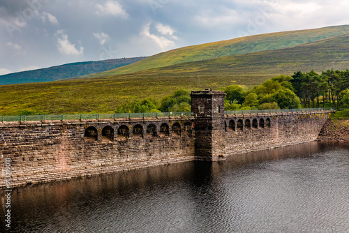 Dam wall of an old reservoir in a rural landscape on a stormy day (Grwyne Fawr) photo