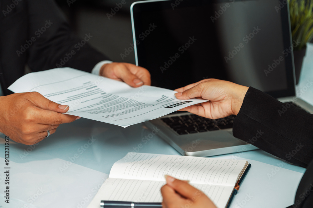 Close up view of employee candidate hands CV resume document to the interviewer HR human resources department manager at the interview room. Job application, recruit and labor hiring concept. uds Close up view of employee candidate hands CV resume document to the interviewer HR human resources department manager at the interview room. Job application, recruit and labor hiring concept. uds