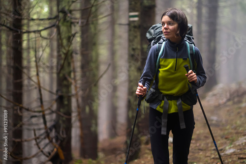 A young girl is engaged in active pastime, walks in the mountains along the trail, 