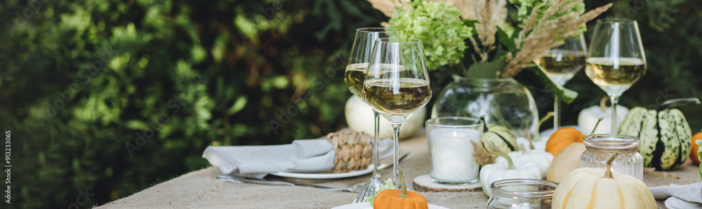 Fall still-life. Orange pumpkins, dry flowers and candles on linen tablecloth. Dinner table outdoors in the garden. Cozy autumn concept., simple handmade decoration, countryside style banner Fall still-life. Orange pumpkins, dry flowers and candles on linen tablecloth. Dinner table outdoors in the garden. Cozy autumn concept., simple handmade decoration, countryside style banner
