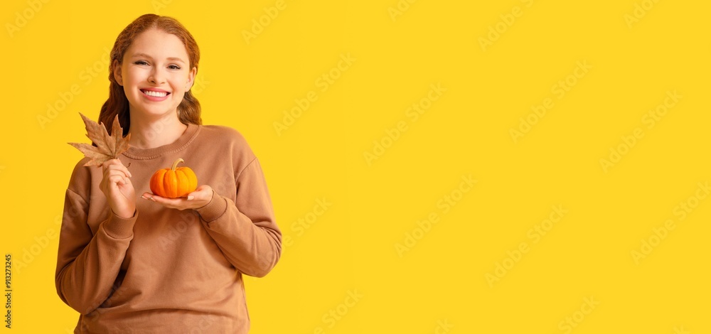 Pretty young woman holding pumpkin and autumn leaf on yellow background with space for text Pretty young woman holding pumpkin and autumn leaf on yellow background with space for text
