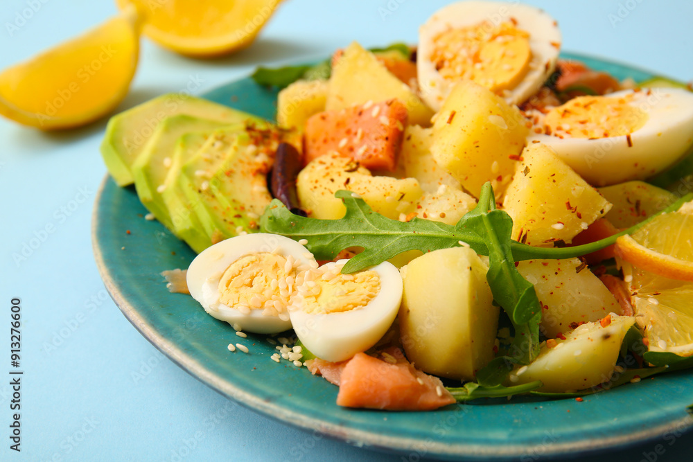 Plate of tasty potato salad with eggs and avocado on light blue background, closeup Plate of tasty potato salad with eggs and avocado on light blue background, closeup