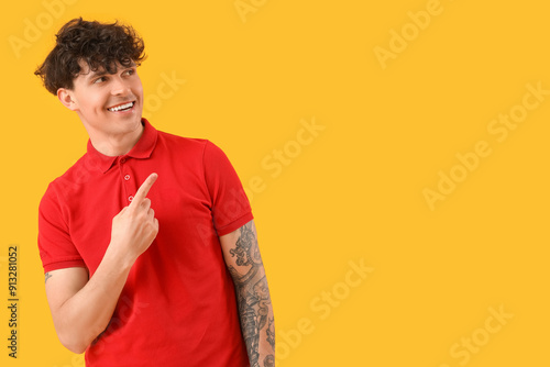 Young man pointing at somet...