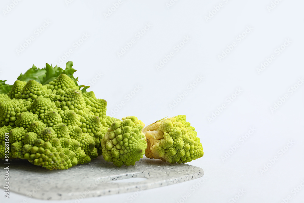 Fototapeta premium Board with fresh Romanesco broccoli on light background
