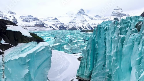 A mountain range with a blue glacier in the middle