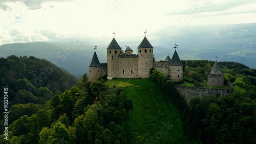 A castle with three towers is on a hill