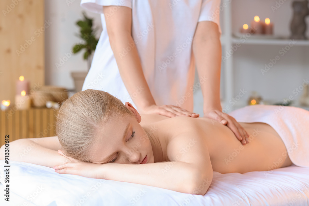 Young woman enjoying relaxing spine massage in spa salon Young woman enjoying relaxing spine massage in spa salon