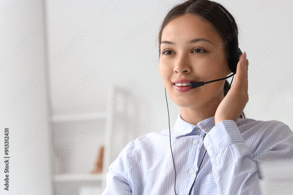 Young female receptionist in headset in office Young female receptionist in headset in office