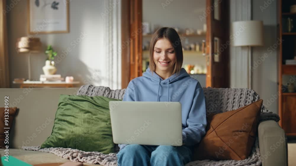 Smiling girl browsing website on laptop sitting home sofa closeup. Happy woman 