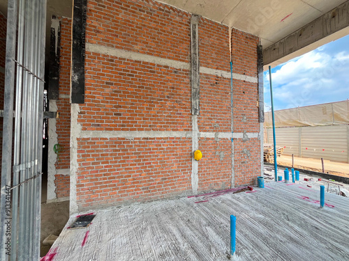 A brick wall under construction that has not been plastered yet.