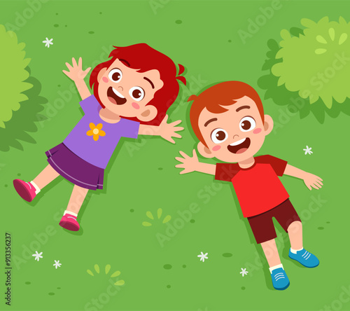 little kid lay down on park and feel happy
