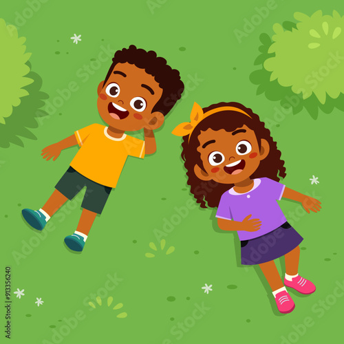 little kid lay down on park and feel happy