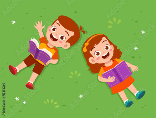 little kid lay down and read book on park and feel happy