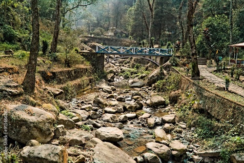 Fotografi landscape view of rock garden with a bridge for walking over the rocks in Darjee