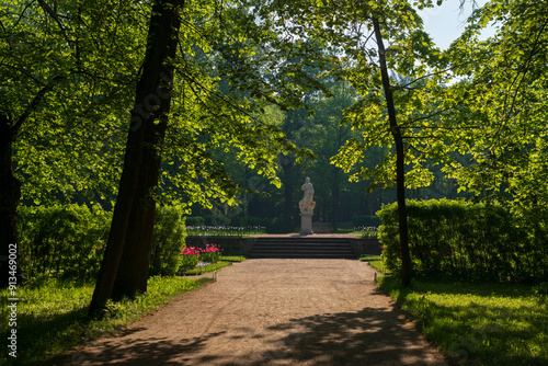 View of the alley in the palace part of Pavlovsk Park and the statue of Peace on a sunny summer day, Pavlovsk, Saint Petersburg, Russia photo