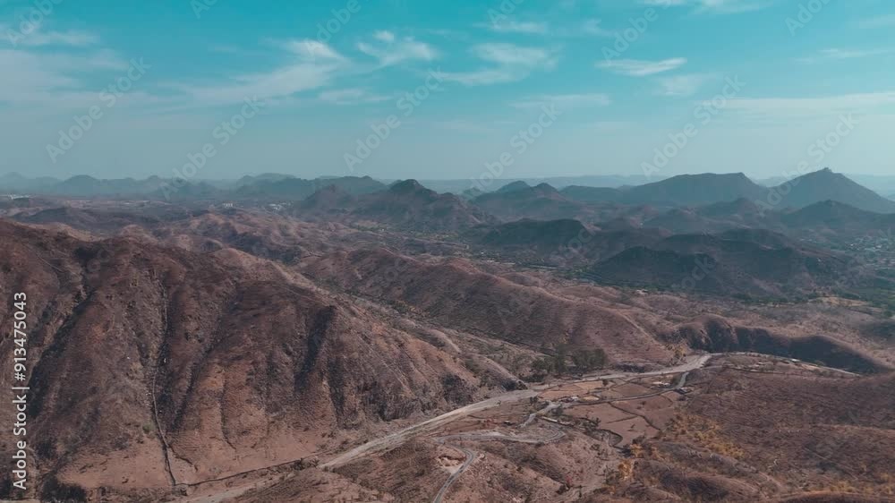 Explore Rajasthan's hills and mountains with our stunning drone video. Glide over majestic peaks and rolling hills, capturing the vibrant landscapes and intricate patterns of this diverse terrain. Exp Explore Rajasthan's hills and mountains with our stunning drone video. Glide over majestic peaks and rolling hills, capturing the vibrant landscapes and intricate patterns of this diverse terrain. Exp