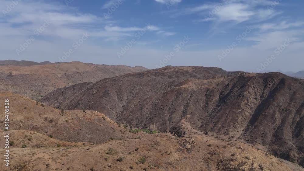 Explore Rajasthan's hills and mountains with our stunning drone video. Glide over majestic peaks and rolling hills, capturing the vibrant landscapes and intricate patterns of this diverse terrain. Exp Explore Rajasthan's hills and mountains with our stunning drone video. Glide over majestic peaks and rolling hills, capturing the vibrant landscapes and intricate patterns of this diverse terrain. Exp