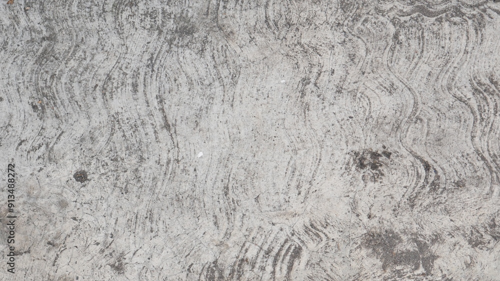 Naklejka premium Attractive modern raw and uneven concrete wall surface handmade gray texture with visible natural traces, texture and mortar structure